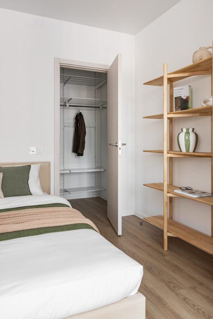Bedroom organisation with open closet and wooden shelves